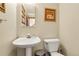 Charming powder room features a pedestal sink and decorative wall art at 11411 W Cooper Dr, Littleton, CO 80127