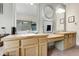 Bright bathroom boasts dual sinks with wood cabinets and vanity area at 11411 W Cooper Dr, Littleton, CO 80127