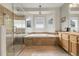 Spa-like bathroom features a soaking tub, glass-enclosed shower, and tiled surround at 11411 W Cooper Dr, Littleton, CO 80127