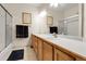 Bright bathroom featuring double sinks, granite counters, and a glass shower enclosure at 11411 W Cooper Dr, Littleton, CO 80127