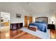 Spacious bedroom features wood floors, natural light and a decorative trunk at 11411 W Cooper Dr, Littleton, CO 80127