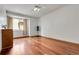 Bright bedroom with hardwood floors, a ceiling fan, and natural light from a window at 11411 W Cooper Dr, Littleton, CO 80127