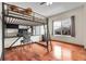 Bedroom featuring hardwood floors, a lofted bed, a desk, and a window at 11411 W Cooper Dr, Littleton, CO 80127