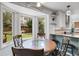 Bright breakfast nook featuring large windows with views of the backyard and modern finishes at 11411 W Cooper Dr, Littleton, CO 80127