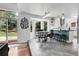Bright dining area featuring a breakfast bar, modern pendant lights, and sliding door to the outdoor patio at 11411 W Cooper Dr, Littleton, CO 80127