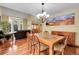 The dining room has a large table, a chandelier, hardwood floors, and lots of natural light from the big windows at 11411 W Cooper Dr, Littleton, CO 80127