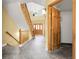 Bright foyer with high ceilings, a chandelier, a wooden front door, and a staircase with carpet at 11411 W Cooper Dr, Littleton, CO 80127