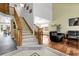 Grand foyer with high ceilings, staircase, wood floors, and elegant tile entryway into the living and dining spaces at 11411 W Cooper Dr, Littleton, CO 80127