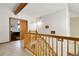 Well-lit staircase leading to the second floor with wood railing at 11411 W Cooper Dr, Littleton, CO 80127