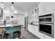 Contemporary kitchen featuring a breakfast bar, stainless steel appliances, and modern finishes at 11411 W Cooper Dr, Littleton, CO 80127