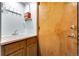 Laundry area with a sink, cabinets, a wooden door, and tiled flooring at 11411 W Cooper Dr, Littleton, CO 80127