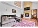 Comfortable living room with high ceilings, a brick fireplace, and hardwood flooring at 11411 W Cooper Dr, Littleton, CO 80127