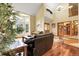A stunning living room with vaulted ceilings, large windows, hardwood floors and a staircase to the second floor at 11411 W Cooper Dr, Littleton, CO 80127