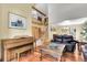 Spacious living room with hardwood floors, a staircase, a piano, and comfortable seating furniture at 11411 W Cooper Dr, Littleton, CO 80127