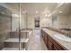 Bathroom featuring double sinks, a soaking tub, and a glass-enclosed shower at 4415 Echo Ct, Larkspur, CO 80118