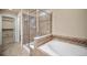 Spa-like bathroom with a glass-enclosed shower and a luxurious tub at 4415 Echo Ct, Larkspur, CO 80118
