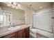 Bathroom featuring a vanity with neutral countertops and a shower/tub combo with glass doors at 4415 Echo Ct, Larkspur, CO 80118