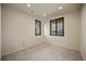 Bright bedroom featuring neutral walls, carpet, and windows with elegant wood-toned shutters at 4415 Echo Ct, Larkspur, CO 80118