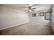 Bedroom with neutral walls, plush carpet, modern ceiling fan, and shuttered windows at 4415 Echo Ct, Larkspur, CO 80118