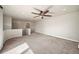 Spacious bonus room featuring neutral walls, tan carpet, and a modern ceiling fan at 4415 Echo Ct, Larkspur, CO 80118