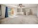 Bonus room featuring neutral walls, tan carpet, a modern ceiling fan, and balcony access at 4415 Echo Ct, Larkspur, CO 80118