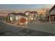 Beautifully designed home exterior, highlighted by warm lighting and stone accents at dusk, offering an inviting ambiance at 4415 Echo Ct, Larkspur, CO 80118