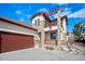 Well-manicured stucco home with stone accents, two car garage and pergola-covered balcony creating a charming facade at 4415 Echo Ct, Larkspur, CO 80118
