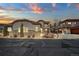 Exterior view of a well-lit home at dusk with stone accents at 4415 Echo Ct, Larkspur, CO 80118