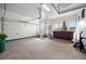Well-lit garage featuring ample space and an adjacent hot tub area at 4415 Echo Ct, Larkspur, CO 80118