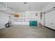 Organized garage space with overhead storage, stairs, and a clean, open layout at 4415 Echo Ct, Larkspur, CO 80118