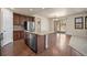 Open concept kitchen with an island, stainless steel appliances, and wooden floors at 4415 Echo Ct, Larkspur, CO 80118