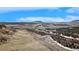 Scenic aerial view shows the property's expansive landscape with rolling hills at 4415 Echo Ct, Larkspur, CO 80118