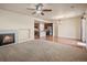 Spacious room featuring fireplace, ceiling fan, modern kitchen and dining area at 4415 Echo Ct, Larkspur, CO 80118