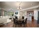 Open-concept living space featuring a modern kitchen, dining area, and cozy fireplace at 4415 Echo Ct, Larkspur, CO 80118