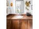 Charming bathroom vanity with a brown countertop, decorative mirror, and plants adding a fresh touch at 7080 W Custer Ave, Lakewood, CO 80226