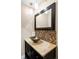 Stylish powder room featuring a vessel sink, granite countertop, and mosaic tile backsplash at 7080 W Custer Ave, Lakewood, CO 80226