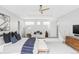 Expansive bedroom with light gray walls, plush carpet, and abundant natural light from multiple windows at 7080 W Custer Ave, Lakewood, CO 80226