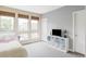 Well lit bedroom features a large window, a storage unit and neutral carpet at 7080 W Custer Ave, Lakewood, CO 80226