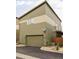 Exterior shot of the home with a two-car garage, modern design, and well-kept yard at 7080 W Custer Ave, Lakewood, CO 80226