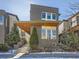 Modern two-story home with a brick facade, a cantilevered porch roof, and manicured landscaping at 7080 W Custer Ave, Lakewood, CO 80226