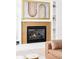 Living room with tiled fireplace and built-in shelving at 7080 W Custer Ave, Lakewood, CO 80226