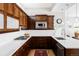 Bright kitchen boasts dark wood cabinets, stainless steel appliances, and white countertops with a gas range at 7080 W Custer Ave, Lakewood, CO 80226
