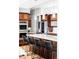 Modern kitchen featuring dark wood cabinets, stainless steel appliances, and an island with bar stool seating at 7080 W Custer Ave, Lakewood, CO 80226
