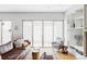 Spacious living room with sliding glass doors to backyard and built-in shelving at 7080 W Custer Ave, Lakewood, CO 80226