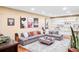 Comfortable living room featuring a sectional sofa, built-in shelving, and movie posters at 7080 W Custer Ave, Lakewood, CO 80226