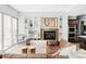 Bright living room with built in shelving surrounding fireplace, plus leather couch and arm chair at 7080 W Custer Ave, Lakewood, CO 80226