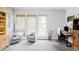Bright office space with neutral gray walls, two chairs, a desk, and large windows at 7080 W Custer Ave, Lakewood, CO 80226