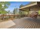 Large back deck with wooden flooring and railing offering a perfect outdoor space at 2317 Wynterbrook Dr, Highlands Ranch, CO 80126