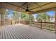 Spacious outdoor back deck with wood railing, ceiling fan, and string lights perfect for entertaining at 2317 Wynterbrook Dr, Highlands Ranch, CO 80126