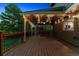 Outdoor back deck with patio cover, string lights, and wood railings, great for evening relaxation at 2317 Wynterbrook Dr, Highlands Ranch, CO 80126